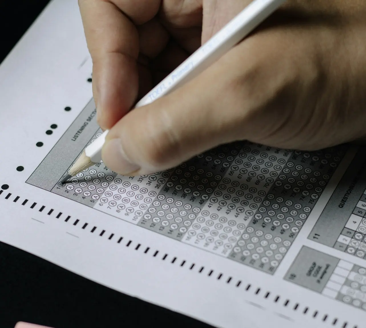 person writing on white paper